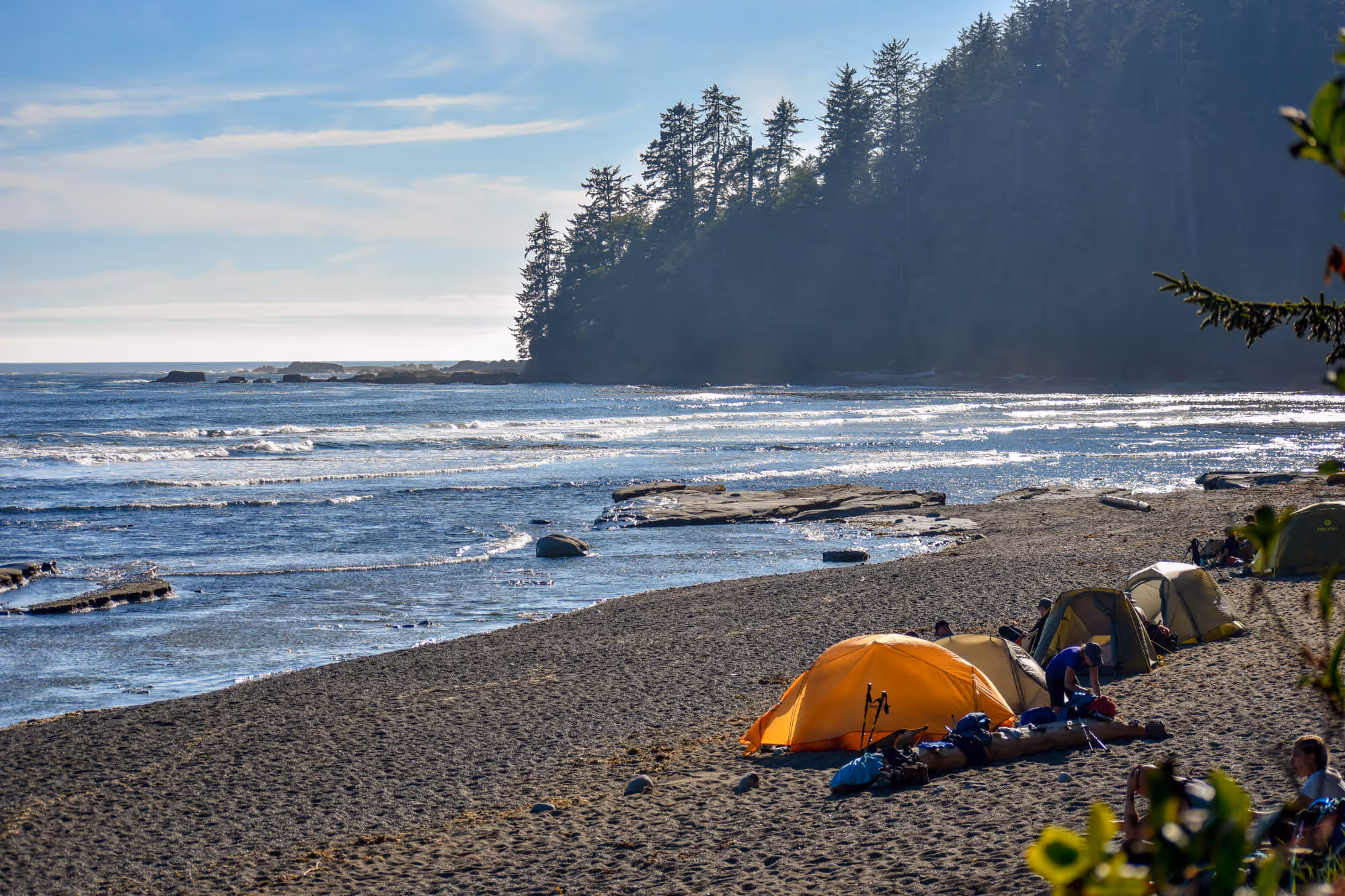 Orange tent perched on beach campsite on west coast trail