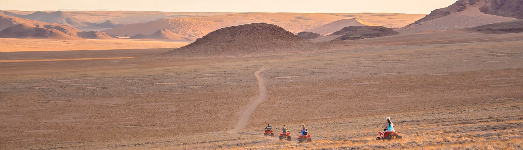 Four quad bikes on an adventure safari across the vast landscape of the Namib Desert.