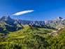 A distant view of the Drakensebrg Mountains from a thatched lodge in the bush.