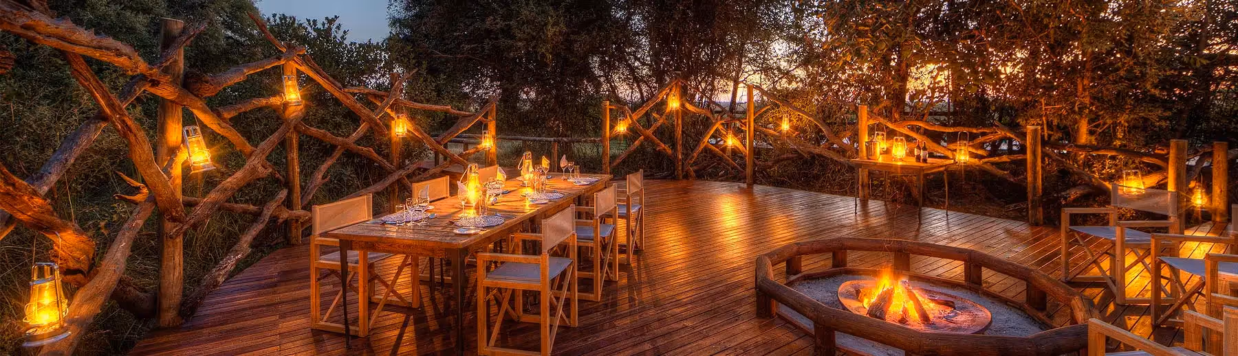Evening enchantment at Camp Moremi: A magical dinner setting, surrounded by the beauty of the wilderness, creating unforgettable moments under the African night sky.