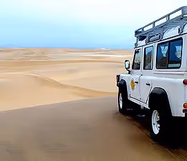 A 4x4 cruiser at a view point on the shore excursion overlooking the dunes of the Skeleton Coast