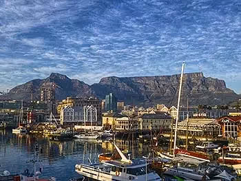 Cappe Town harbour and waterfront with a backdrop of Table Mountain.