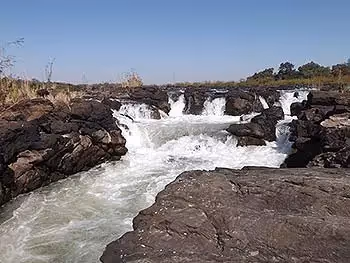 A small waterfall of white water between the rocks. 