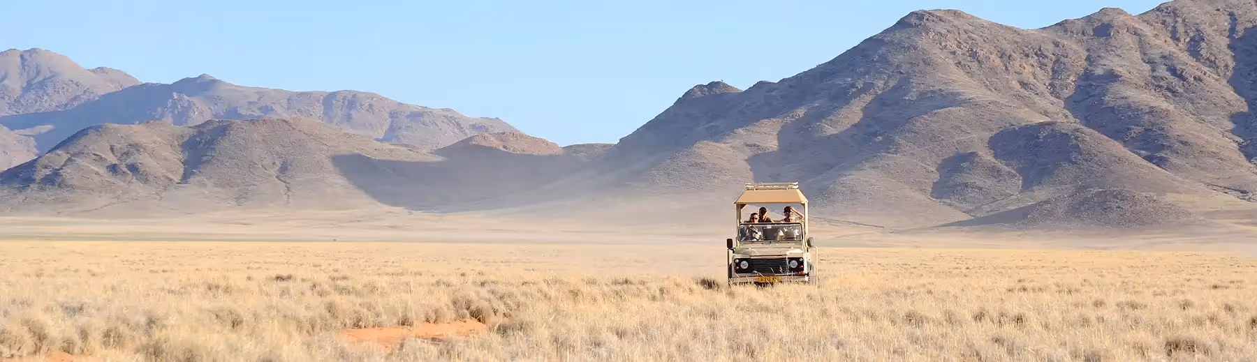 Exclusive-use safari vehicle exploring Namibia’s wide-open landscapes – private guided game drive experience, perfect for longer stays
