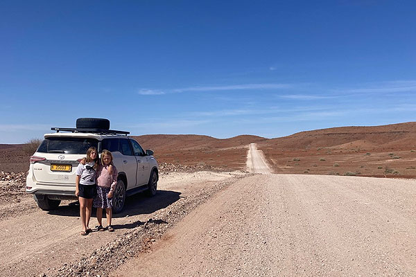 Self-drive family enjoying a relaxed stop on a gravel road in Namibia