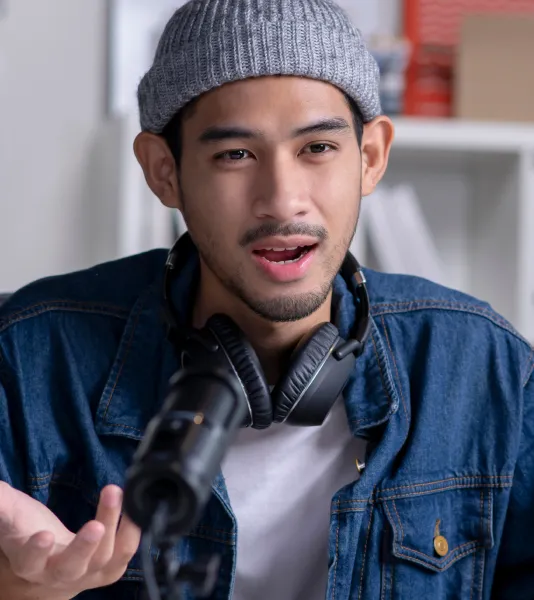 Man in a gray beanie talking into a mic
