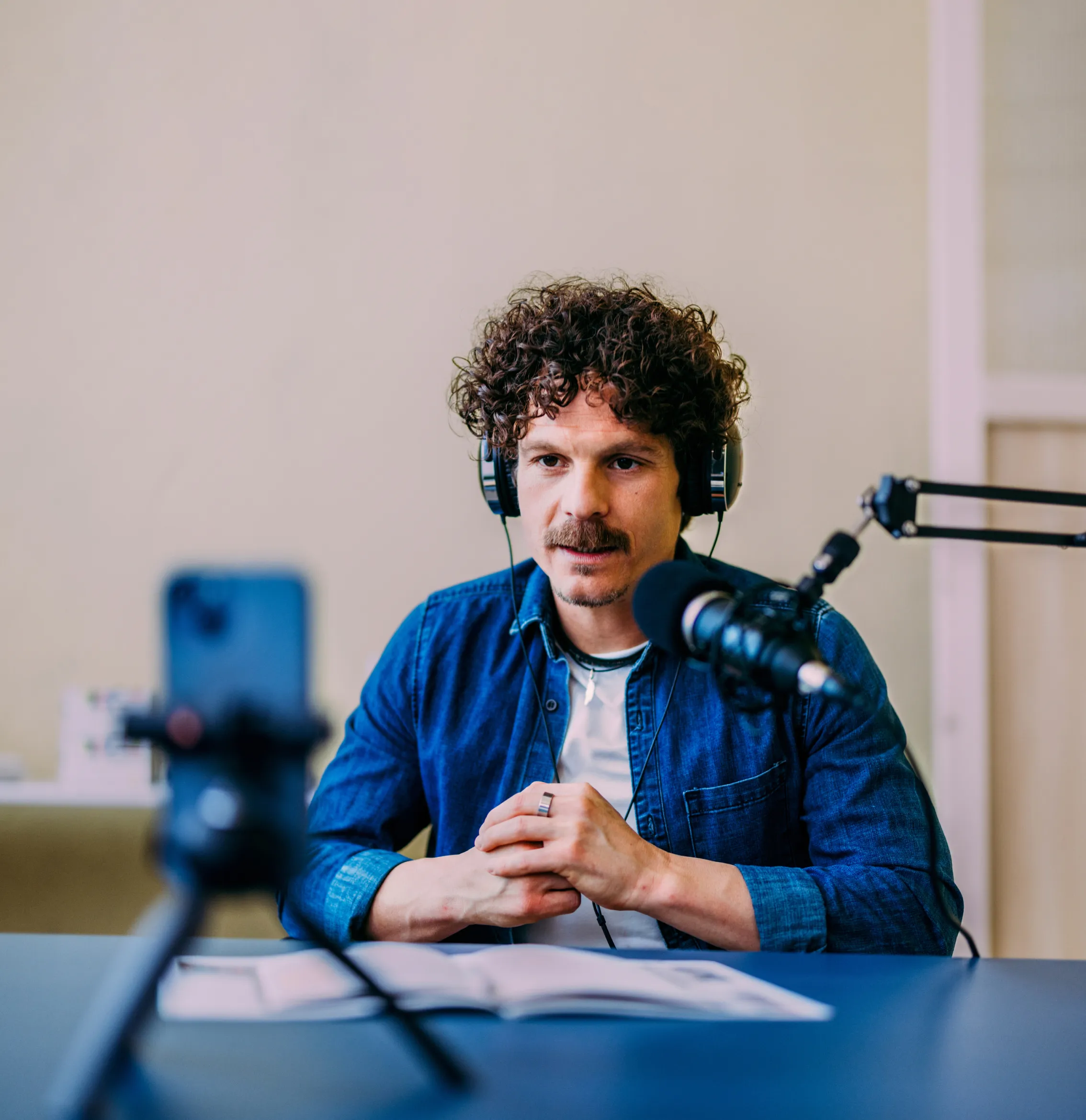 Man recording a podcast on his phone