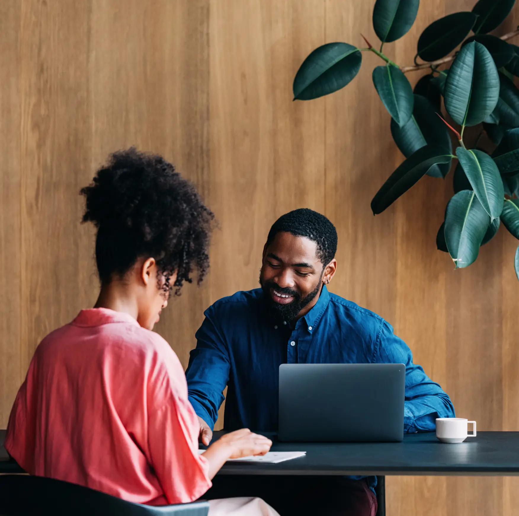 A man and his client reviewing papers together