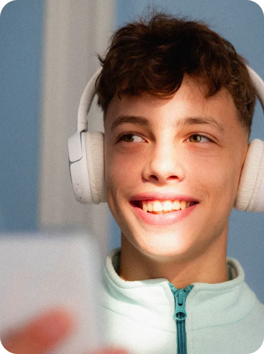Smiling boy using headphones.