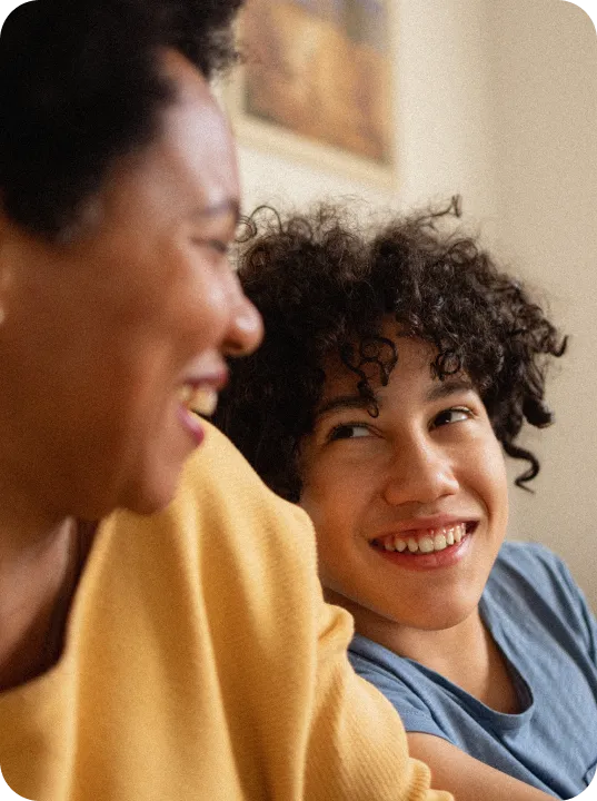 Child laughing with their parent.