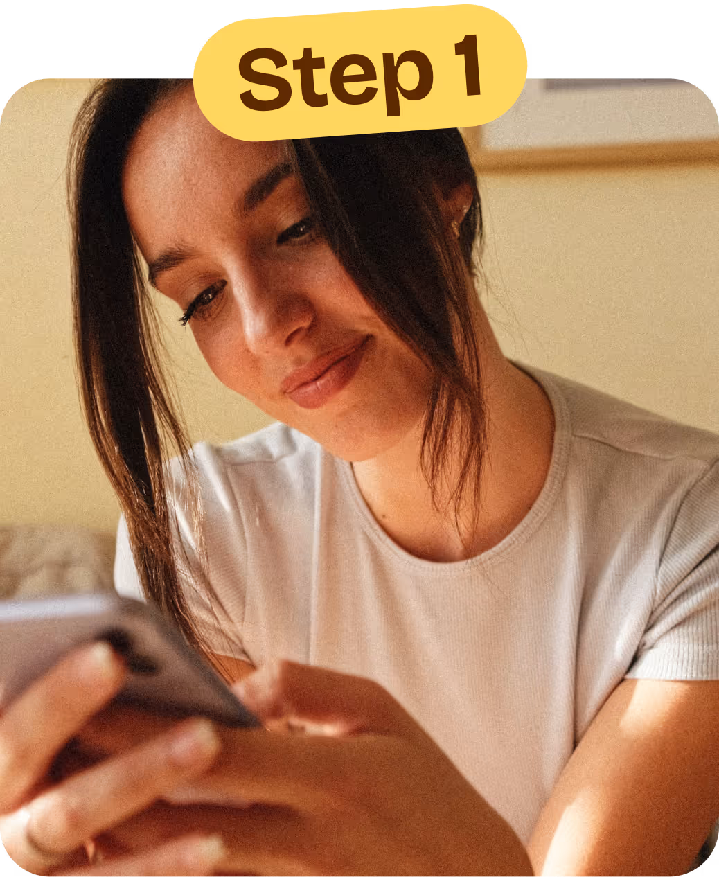 Young mom looking at a mobile device with the Aura app.