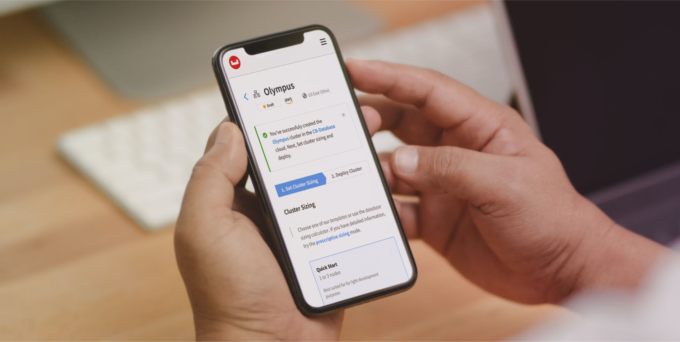 A person holding a mobile device with the Couchbase app open and operating.