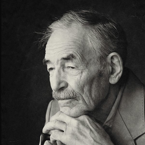 Thoughtful elderly man with cane, captured in a contemplative black and white portrait.