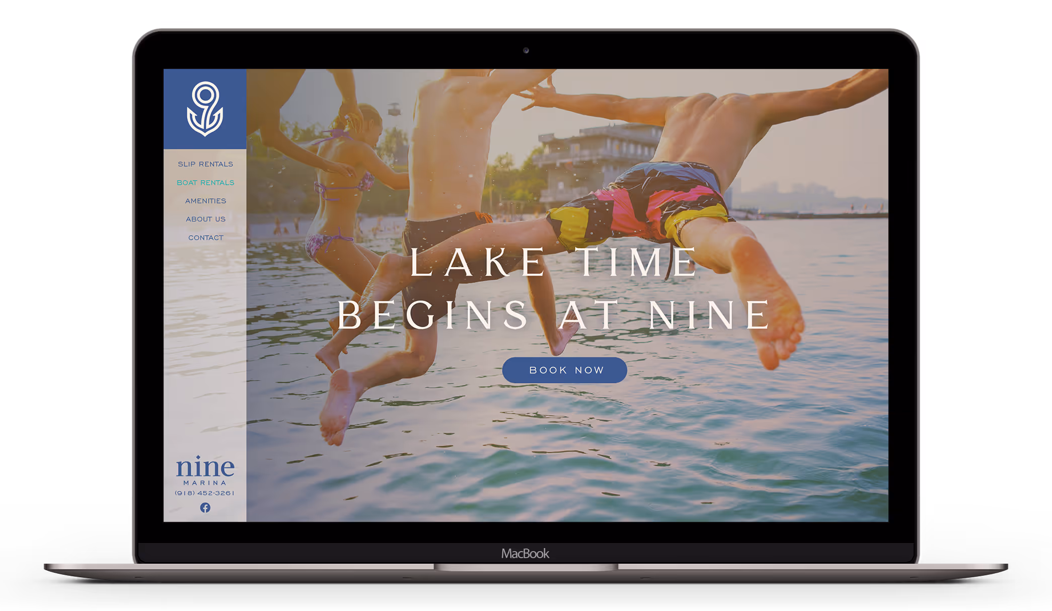 A laptop screen featuring the Nine Marina website.