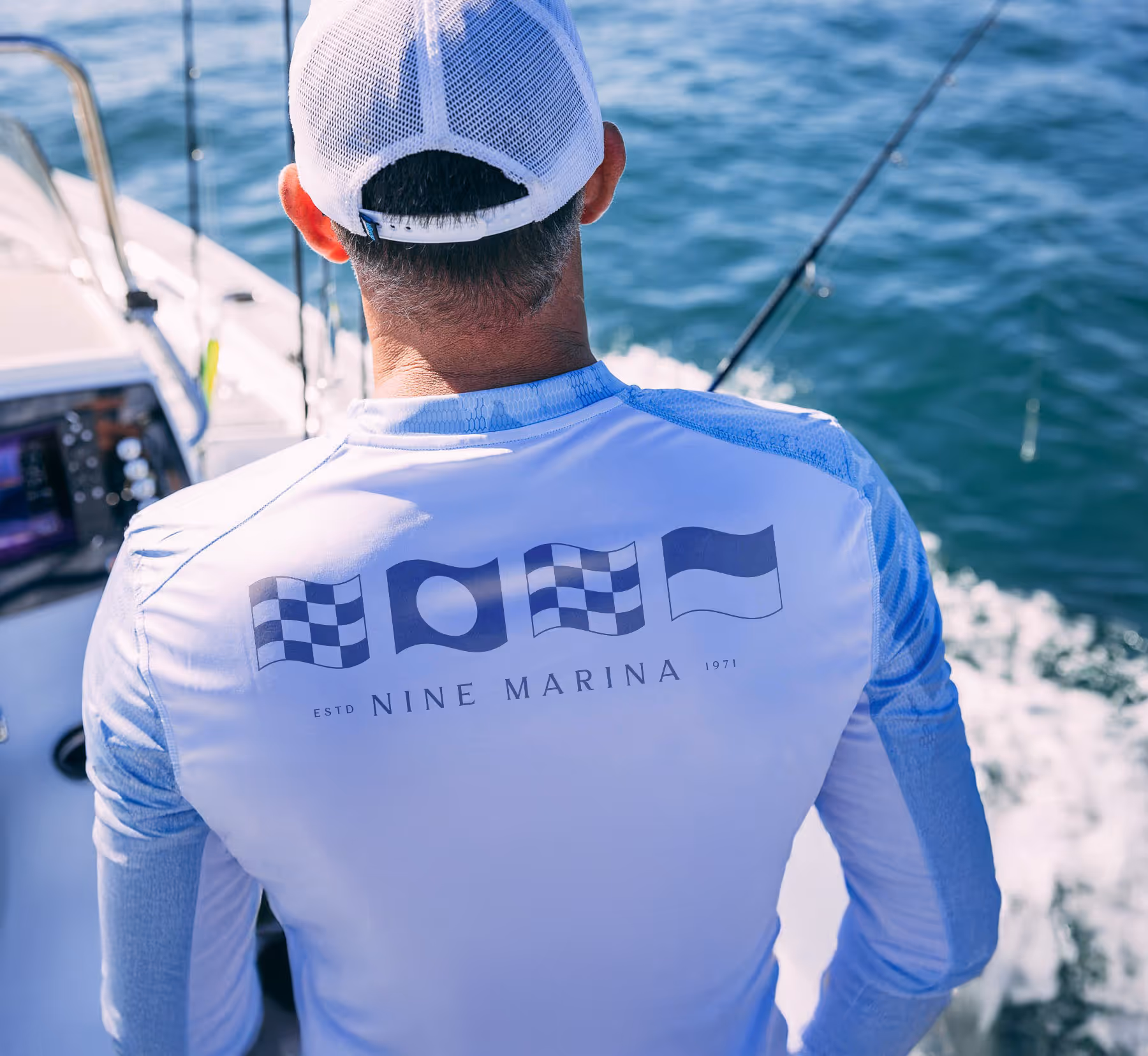 The back of a long sleeve sun shirt with Nine Marina on the back.