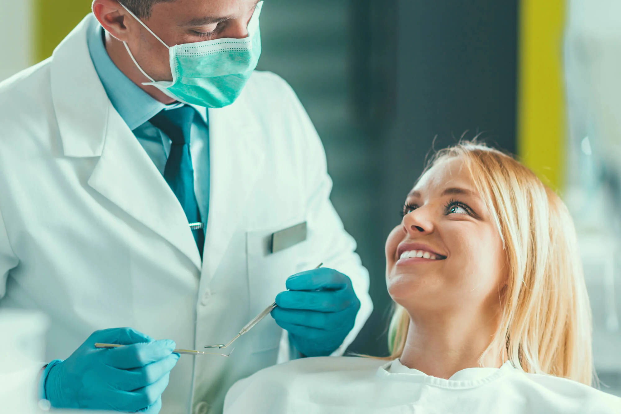 Dentist talking with smiling patient Cosmetic dentist in Clyde, NC