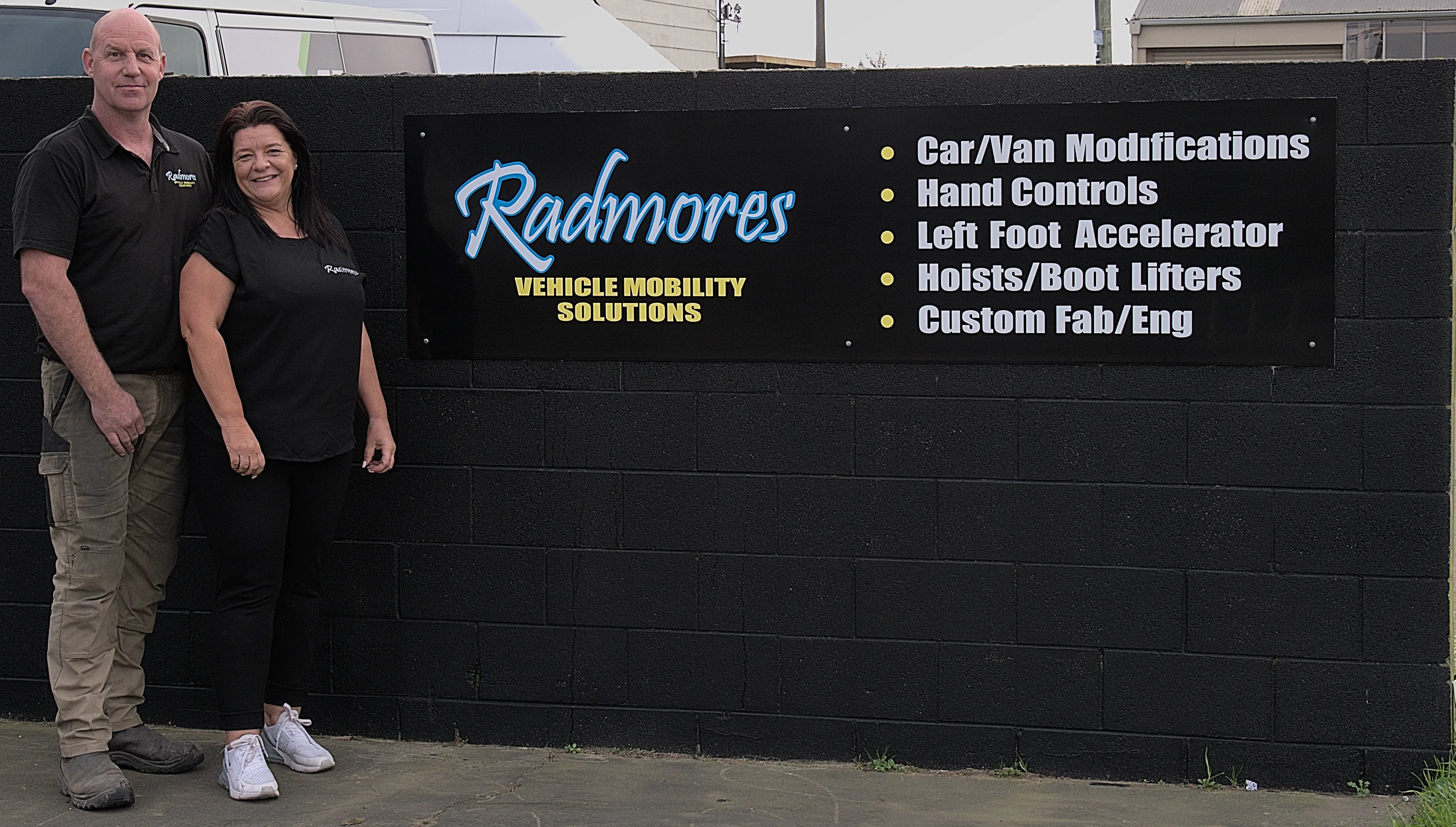 A picture of Conrad and Cherie stood to the left of their business sign.