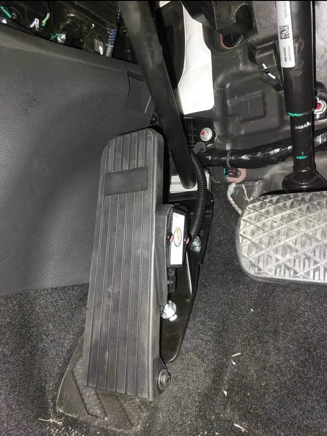 A close up image of an accelerator pedal for a vehicle that has been relocated to the left of the centre brake pedal.