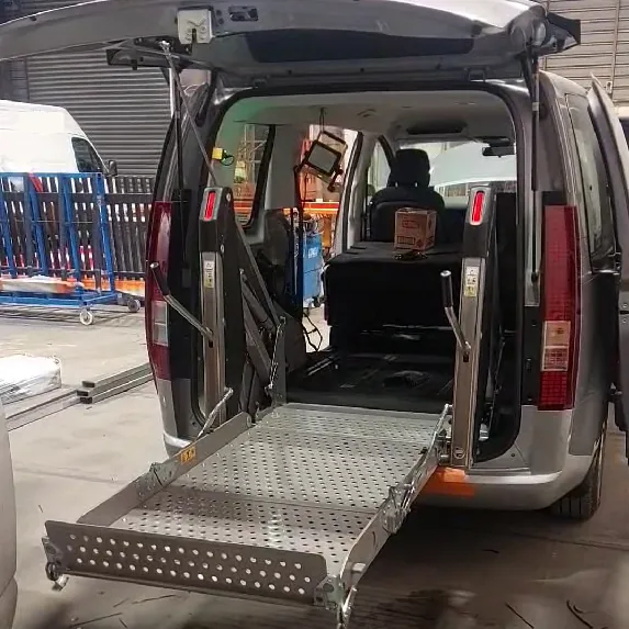 A rear entrance hydraulic vehicle entry hoist.