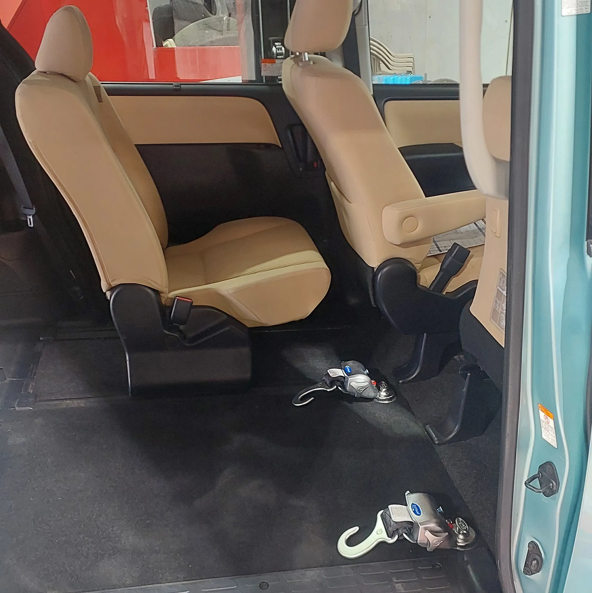 A photo of the interior of a car with a passenger seat removed.