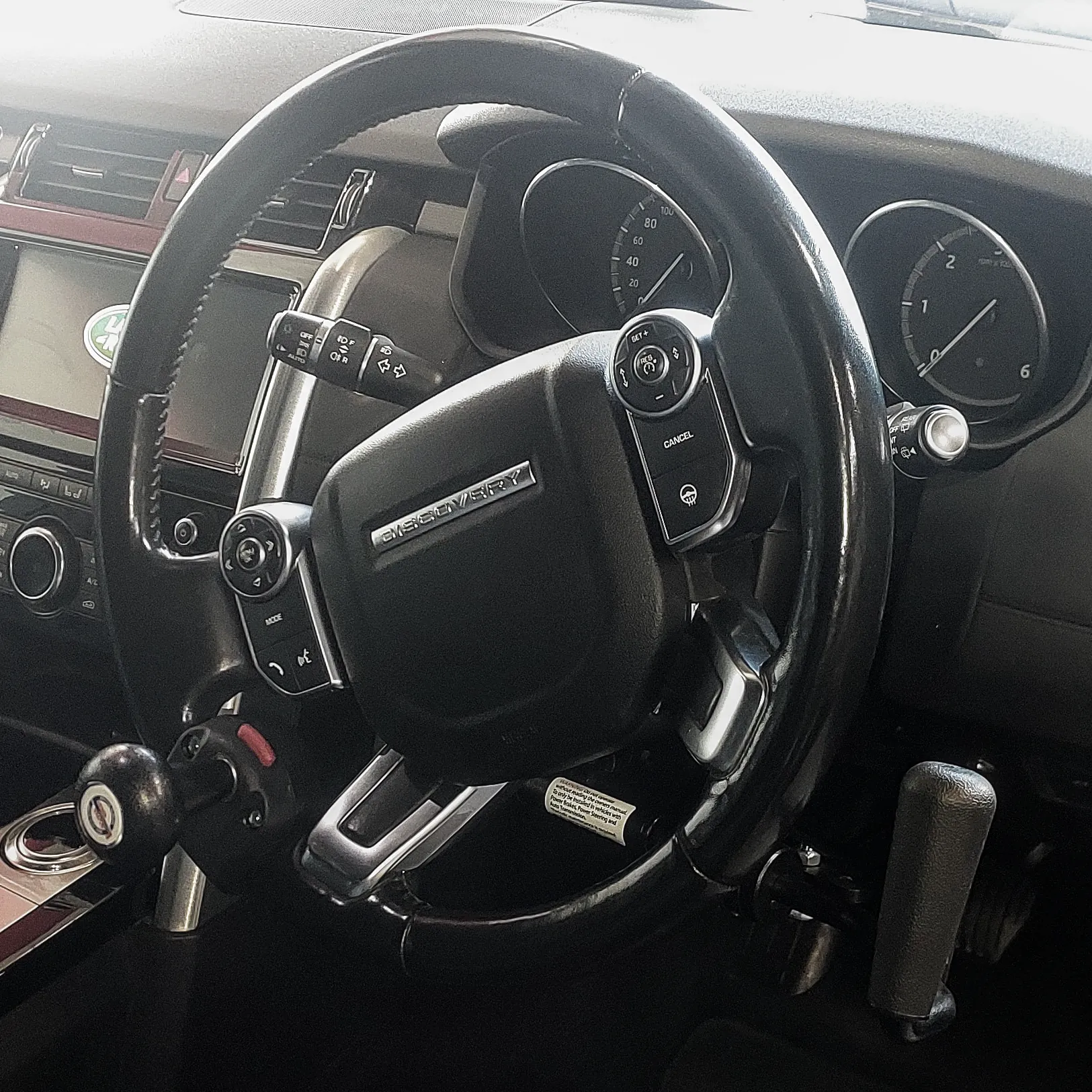 A vehicle steering wheel with control rods.