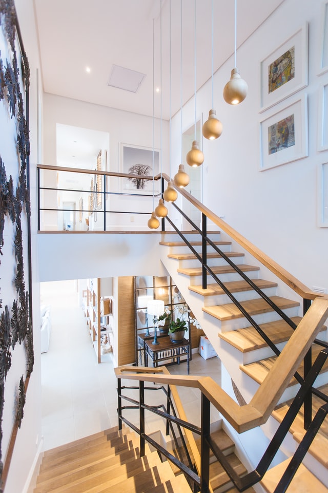 Refinished wooden stair railing by Finishline Cabinets