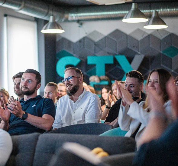 A photo of stx next happy employees on meeting.