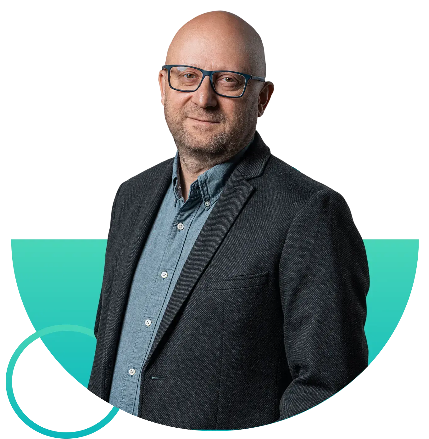 Middle-aged bald man with glasses wearing a blue shirt and dark blazer, smiling slightly.