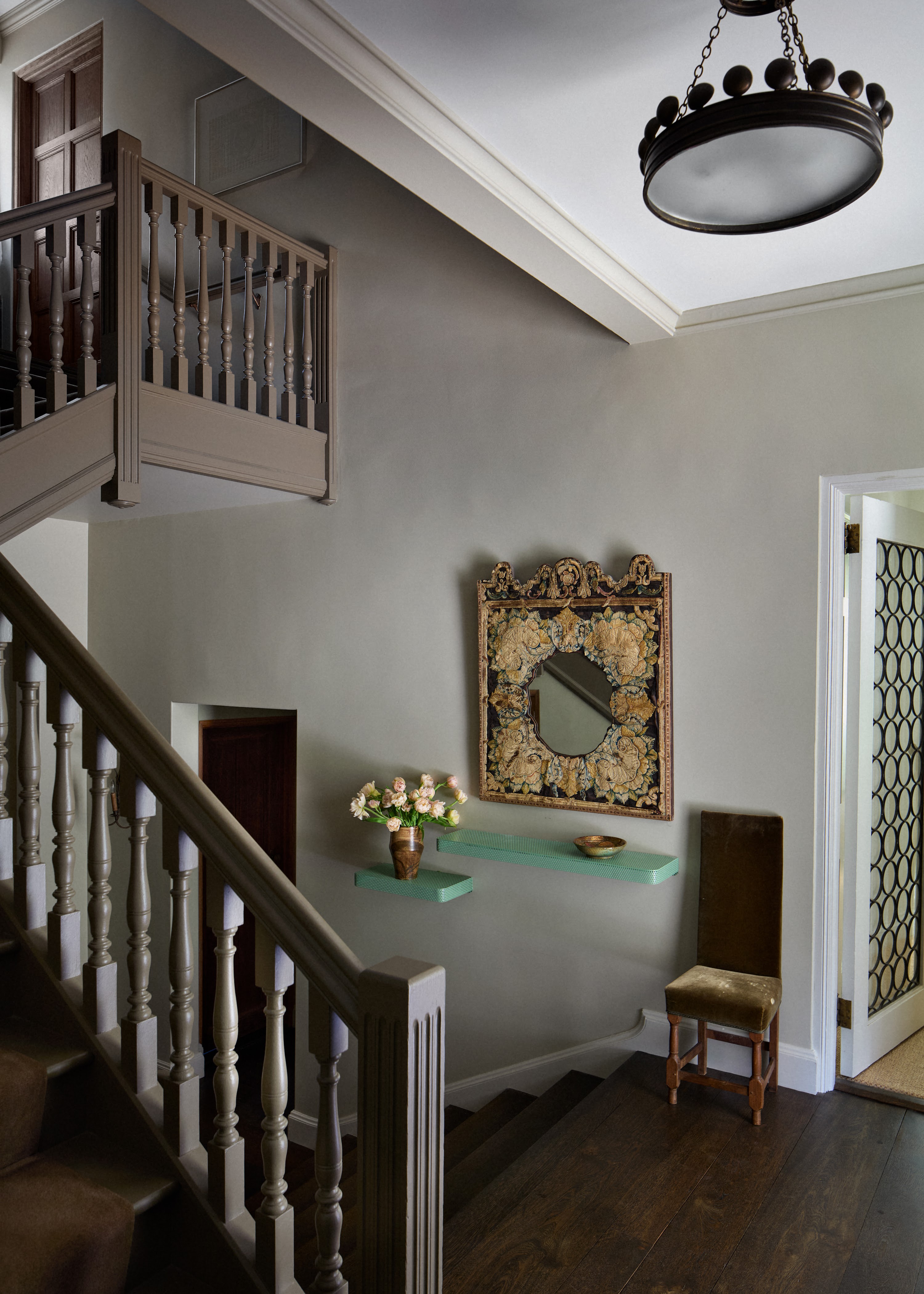 Upstate New York stair hall with a mirror and console