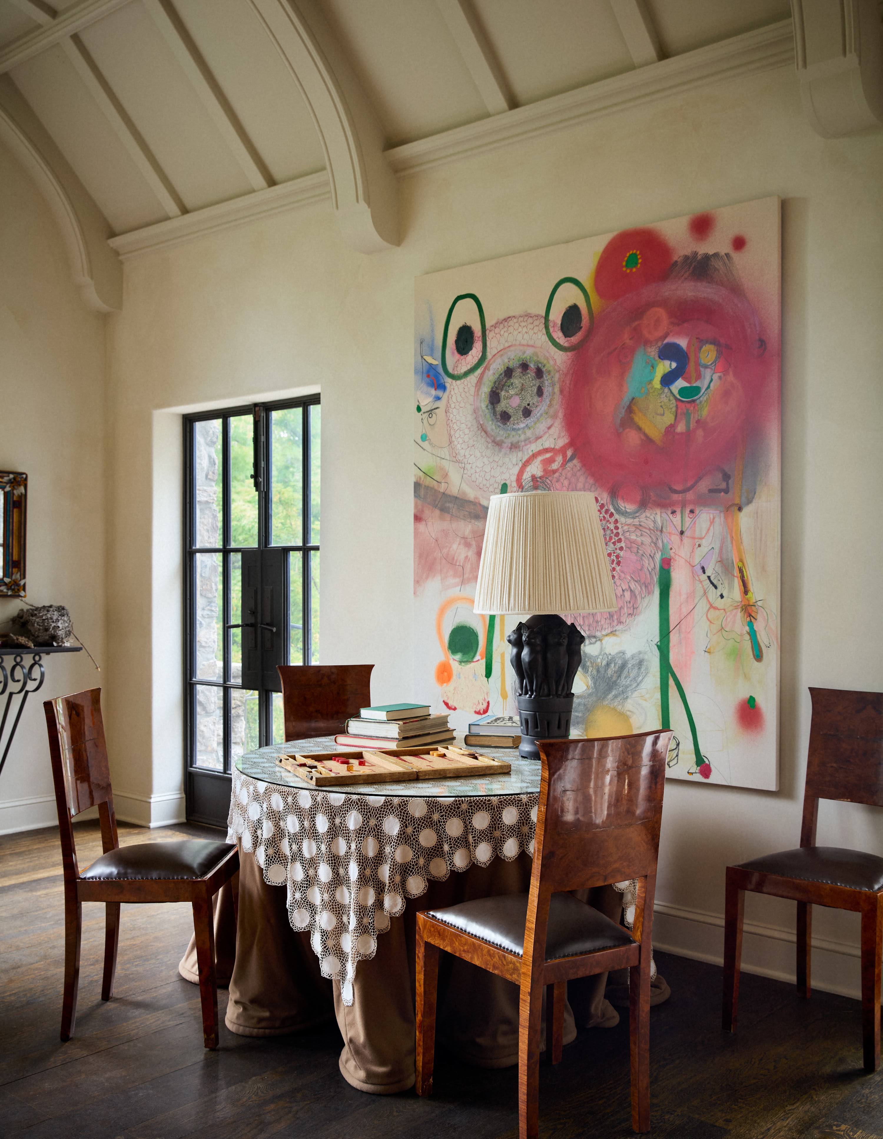 Round table beside colorful artwork in the Upstate New York living room