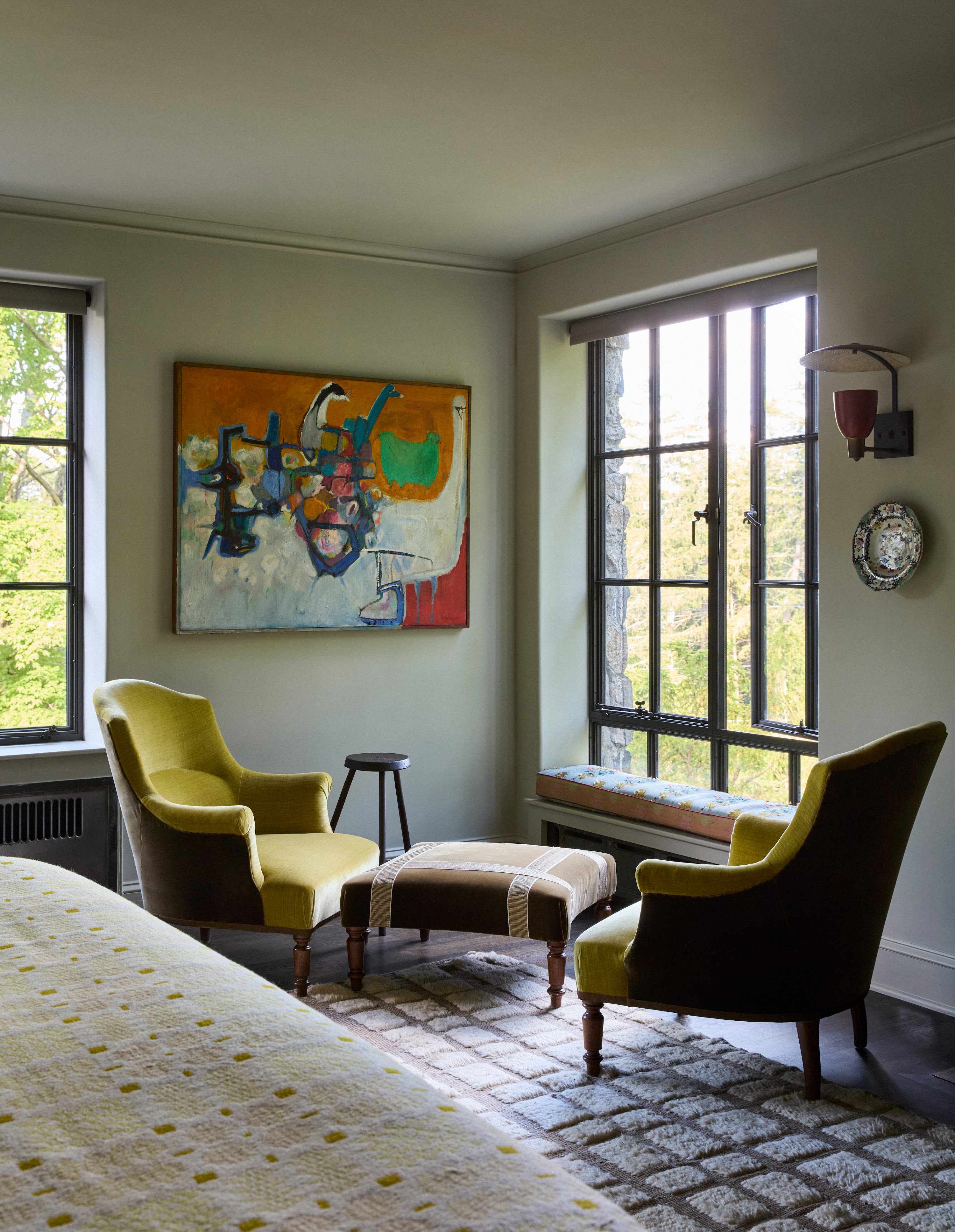 Bedroom seating area beside a tall window in Upstate New York
