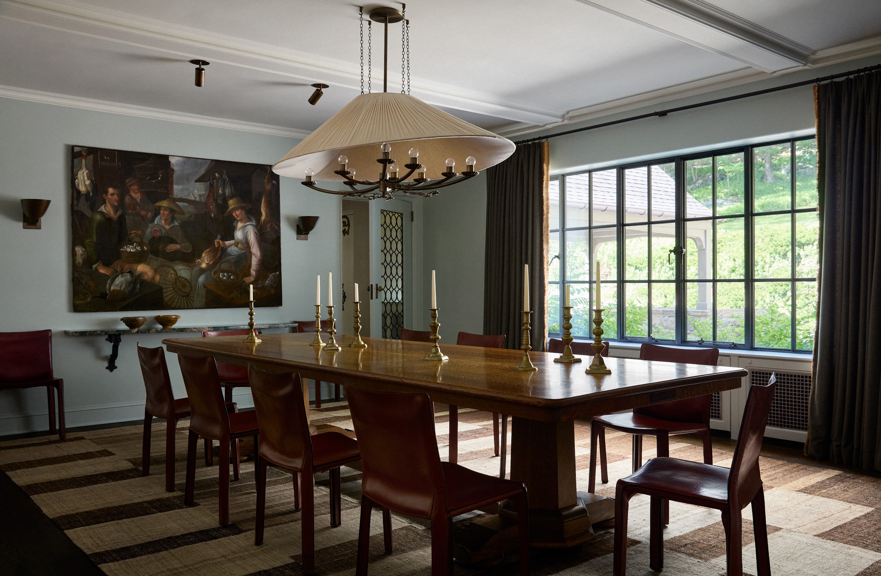 Upstate New York dining room with a long table and pendant light
