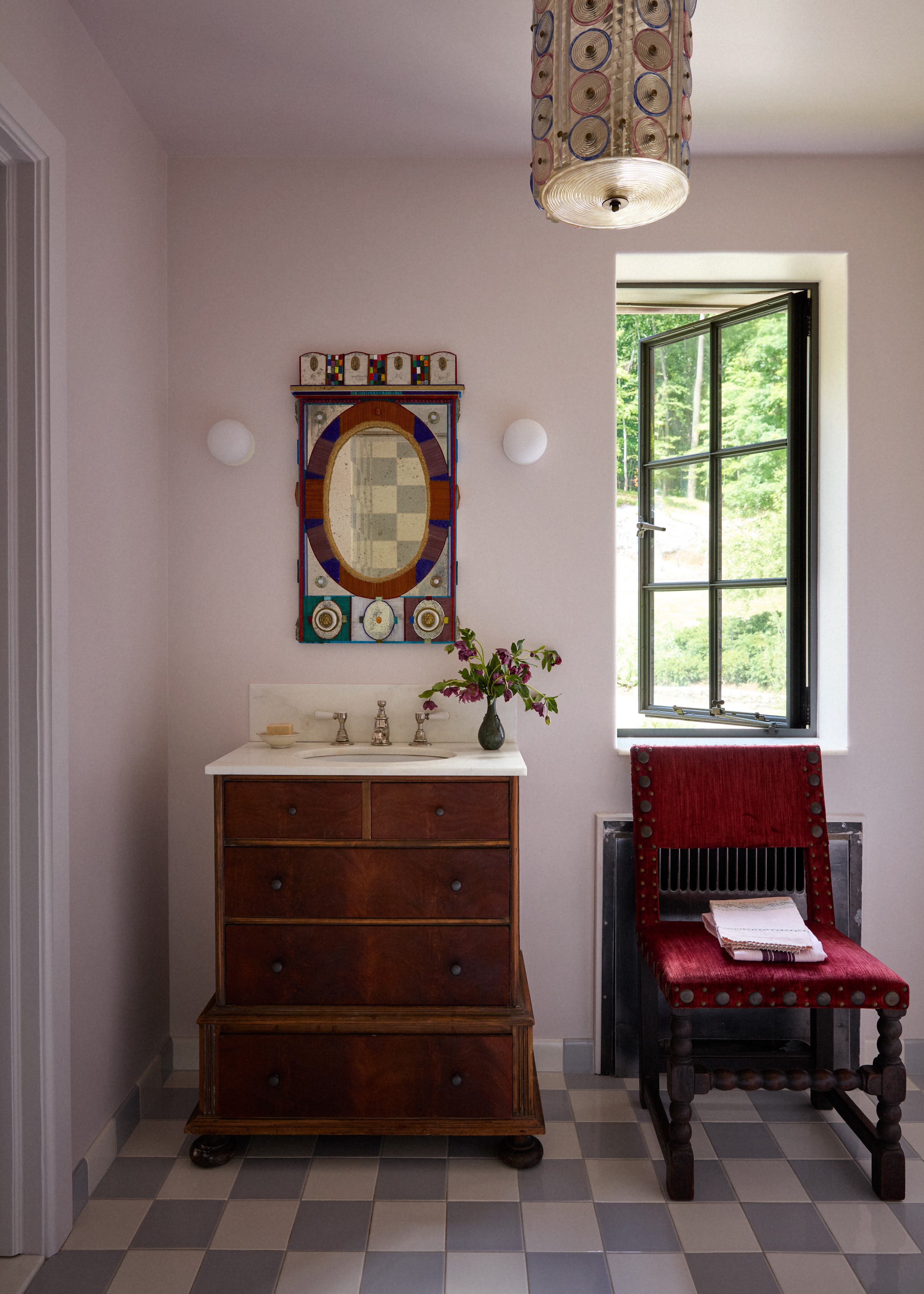 Pink bedroom corner with a dresser and chair in Upstate New York