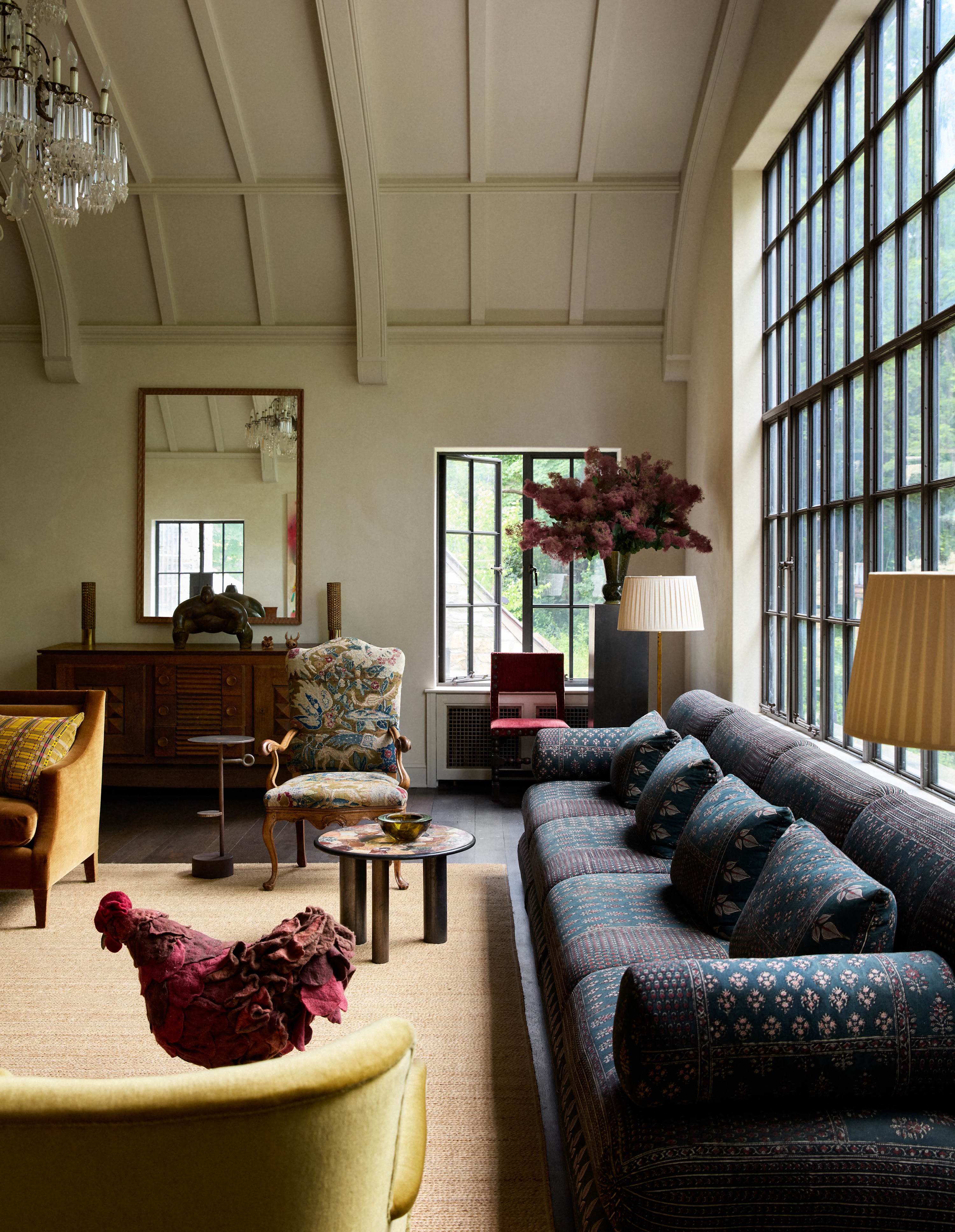 Patterned sofa beneath the tall living room windows in Upstate New York