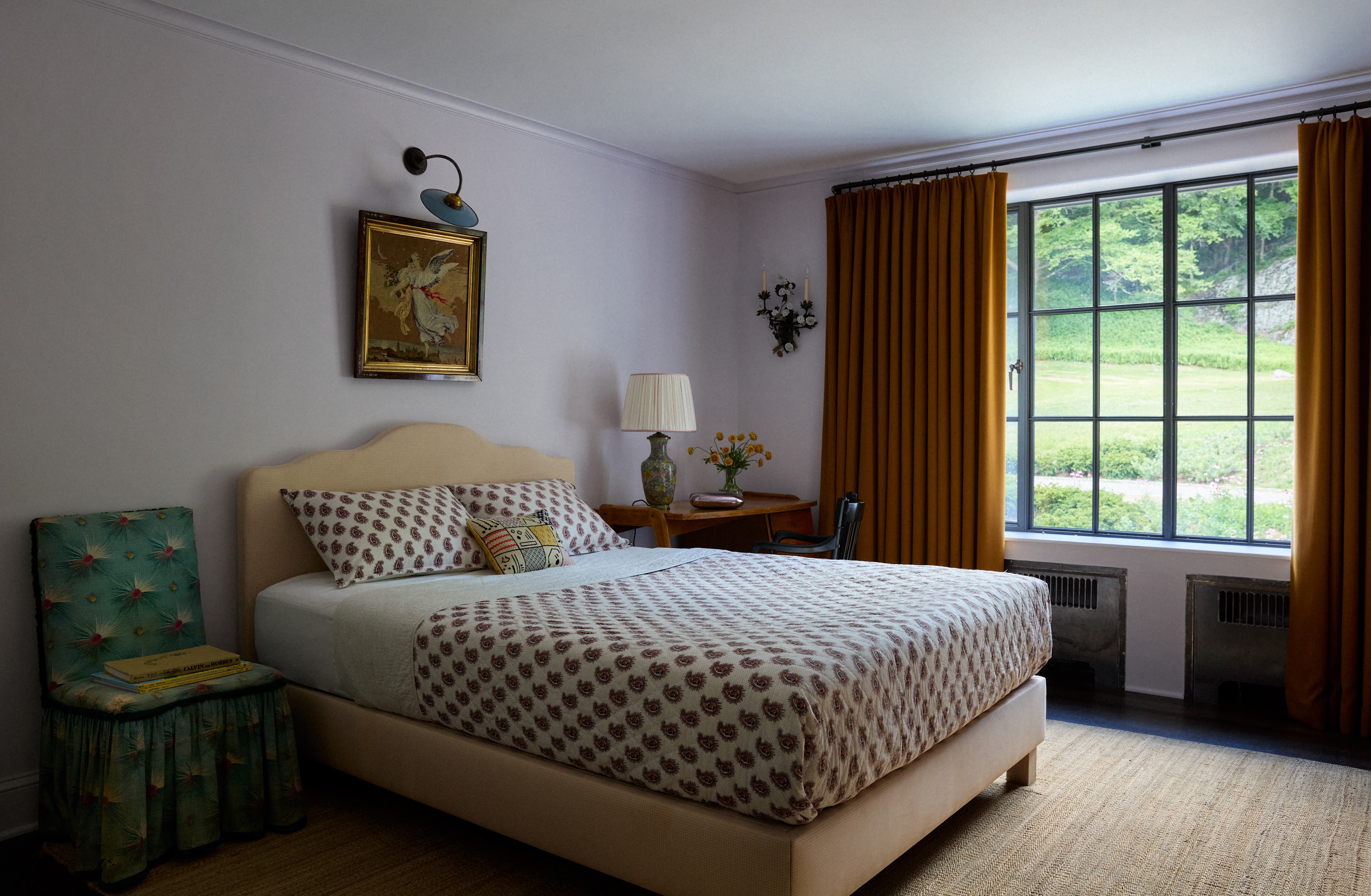 Upstate New York bedroom with a patterned bed and garden-facing window