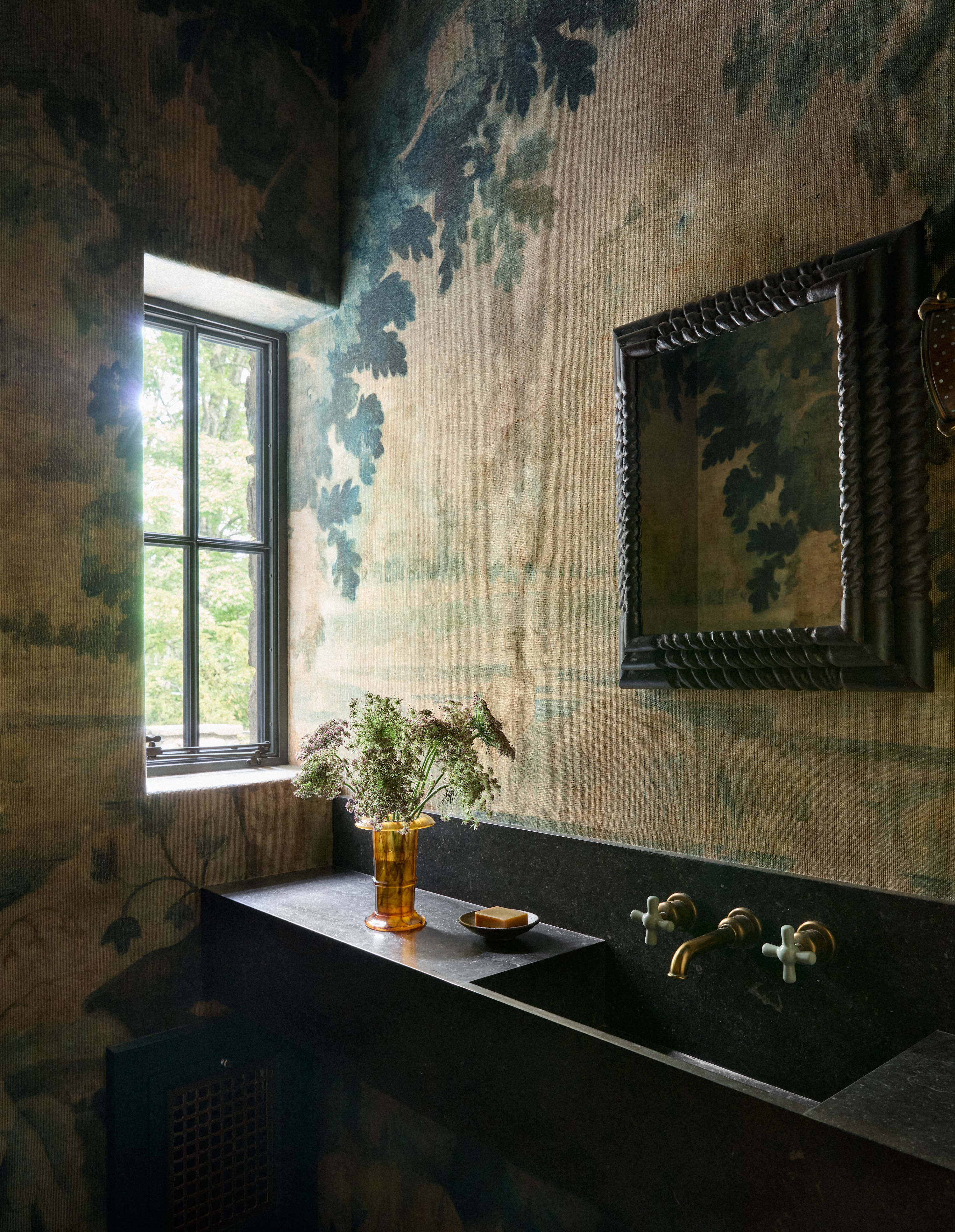 Upstate New York powder room with patterned wallpaper and a dark basin