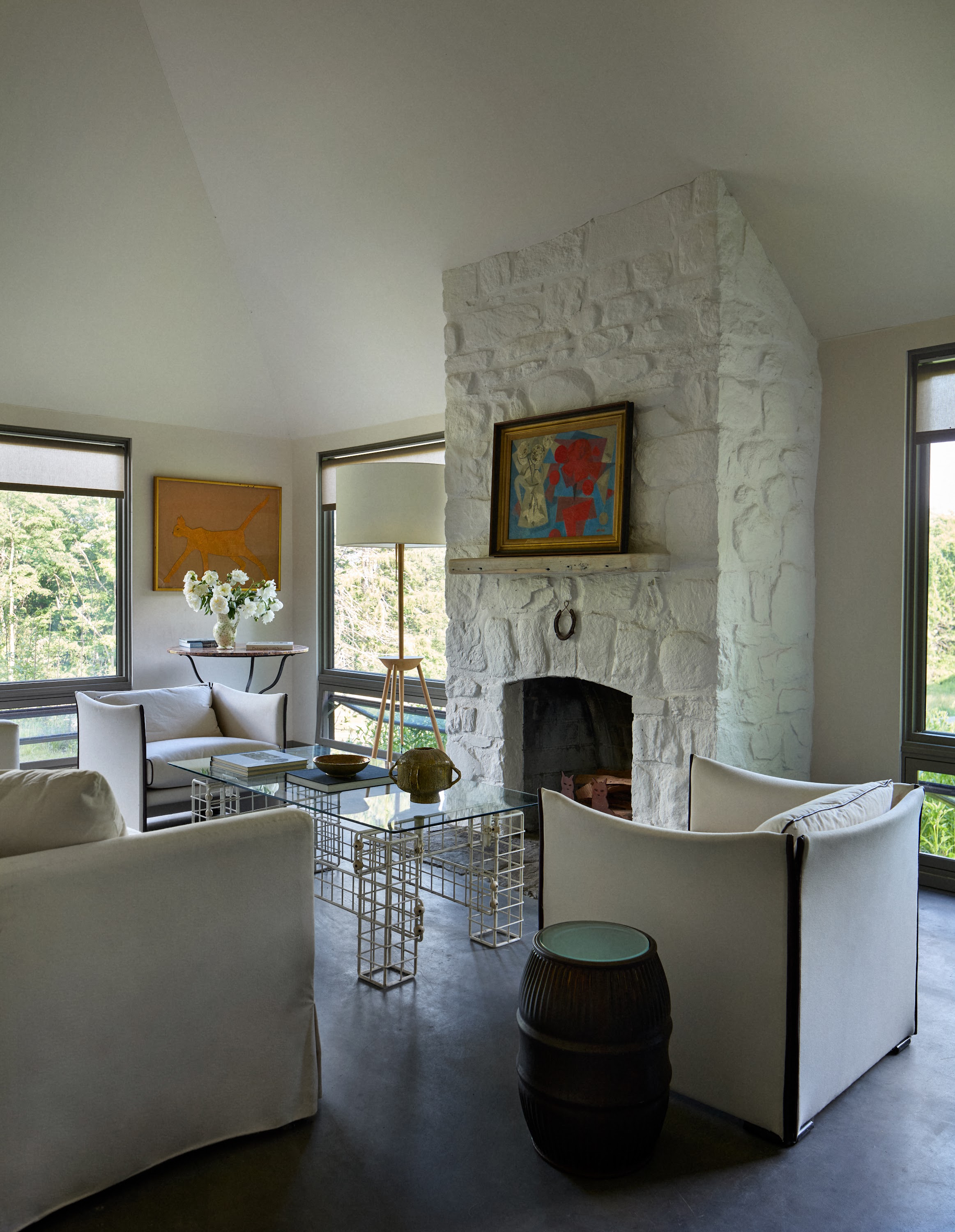 Pool house living room with a stone fireplace in Upstate New York