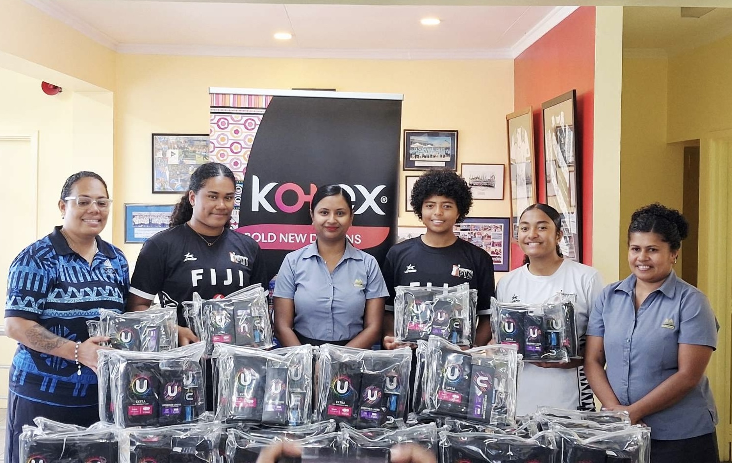 Team Fiji athletes and officials with Motibhai Group staff at the U by Kotex feminine hygiene pack handover for Dakar 2026