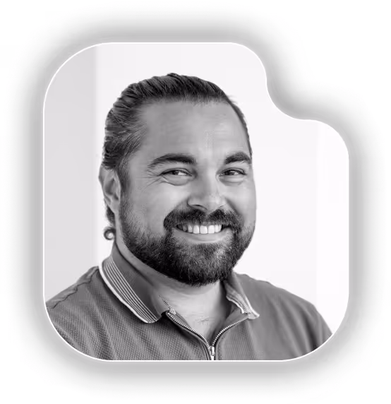 A black and white photo of a man with a beard.