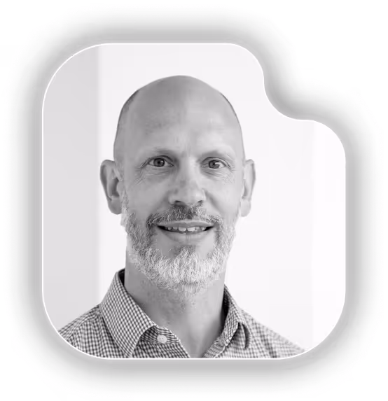 A black and white photo of a man with a bald head.