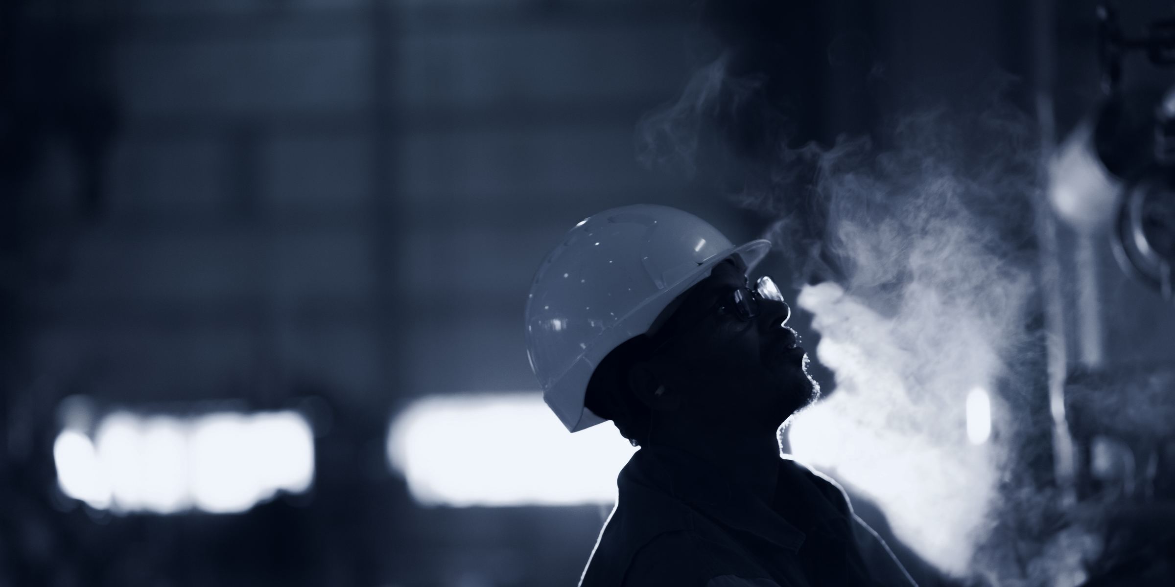 Engineer with a hard hat in a production hall