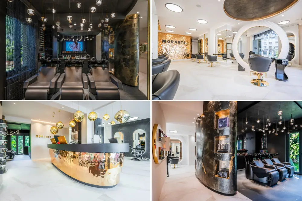 Luxuriöser, naturfarbener Friseursalon mit großen Spiegeln. Braune Sessel in Reihe auf grauem Betonboden. Goldene Empfangstheke mit funkelnden Hängeleuchten und Panoramafenster ins Grüne. Morante