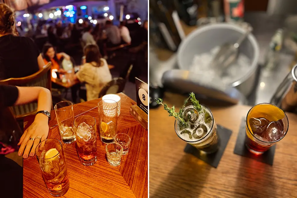 Frauenhand neben Cocktails und Highballs auf dem Tresen in der gutbesuchten Zweibar, Essen-Rüttenscheid