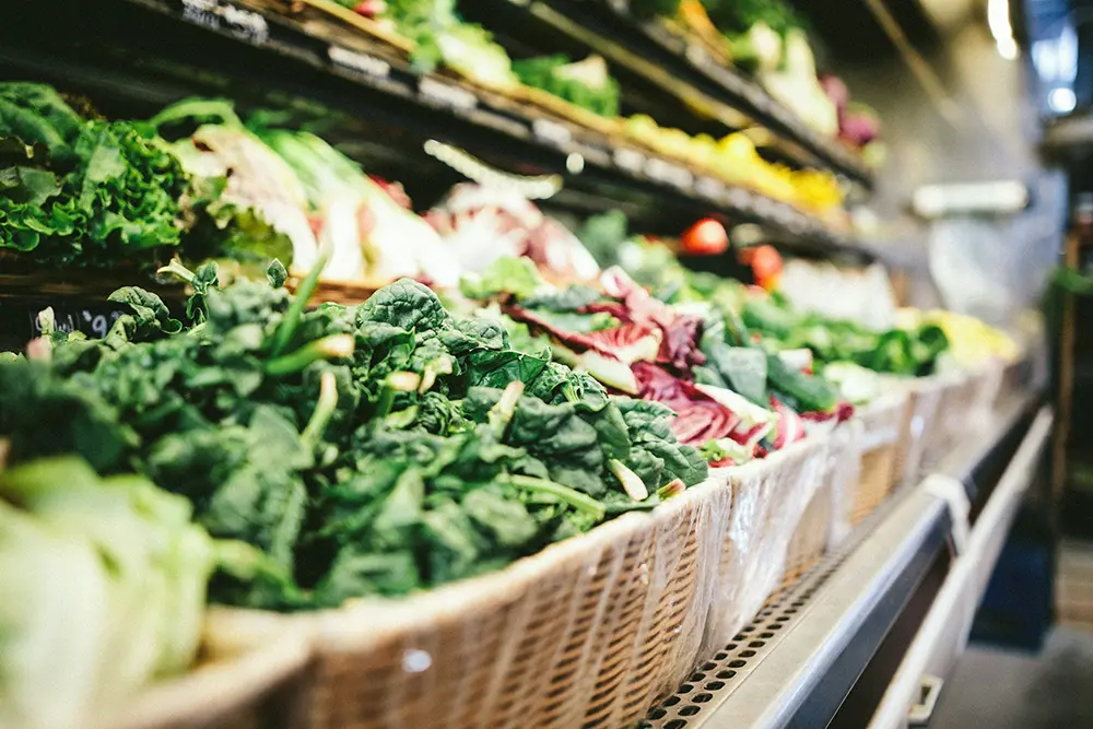 Frisches Bio-Gemüse und Blattsalate in Körben in der neu eröffneten Filiale von Denns BioMarkt nach dem Umzug.
