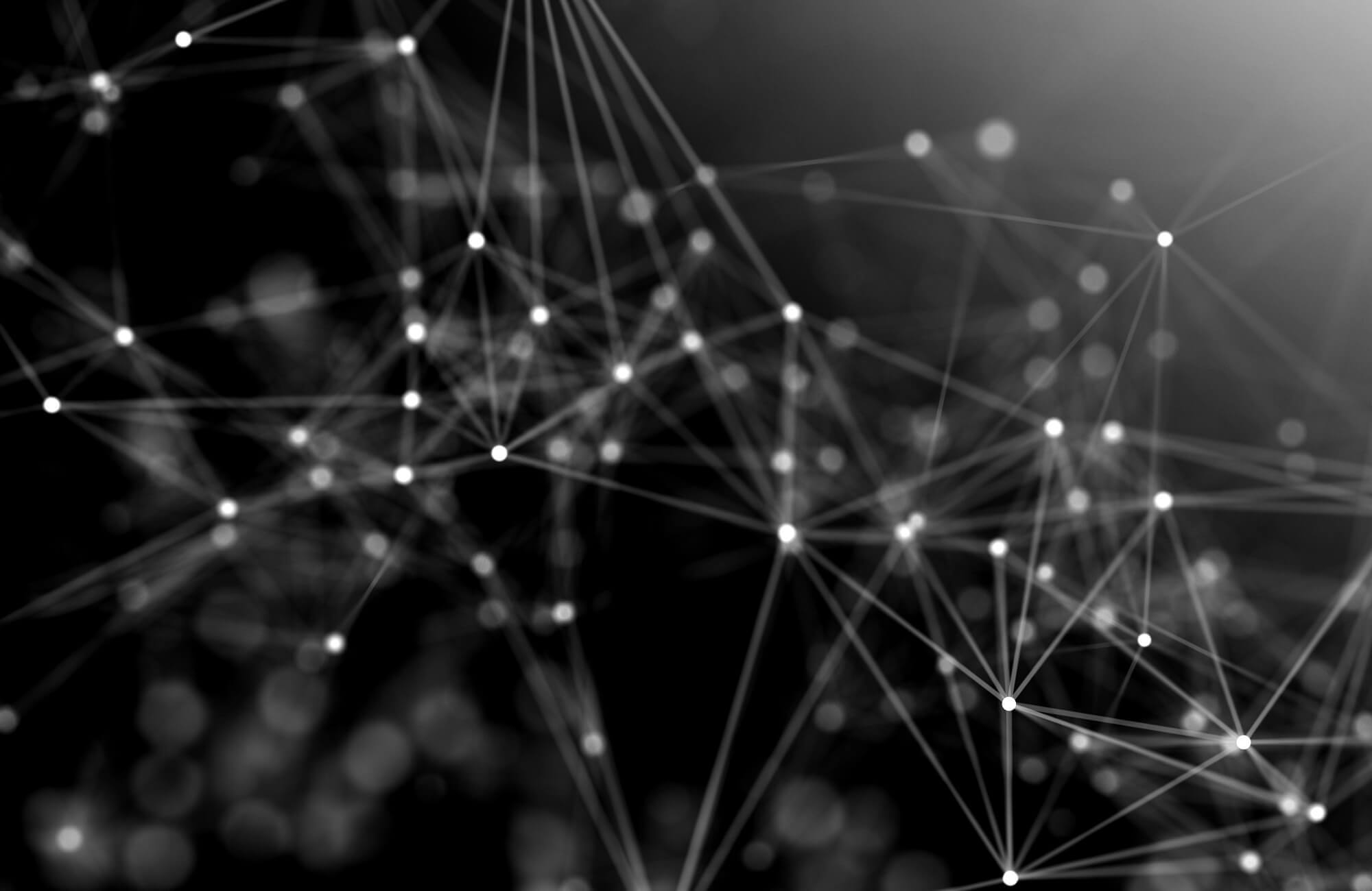 Black and white abstract network structure with connected glowing nodes and lines.