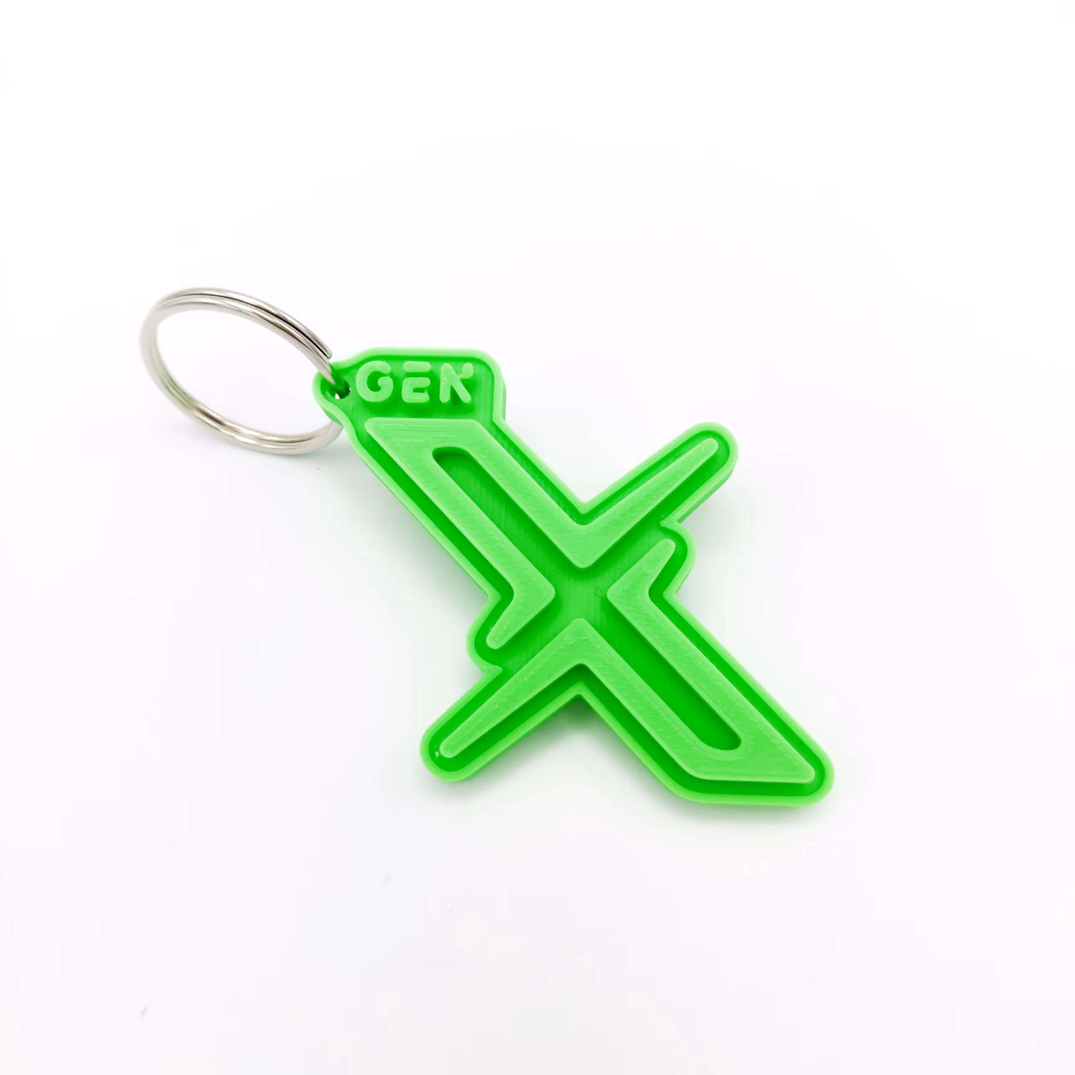 Reliëfsleutelhanger in de vorm van het logo voor het merk GenX