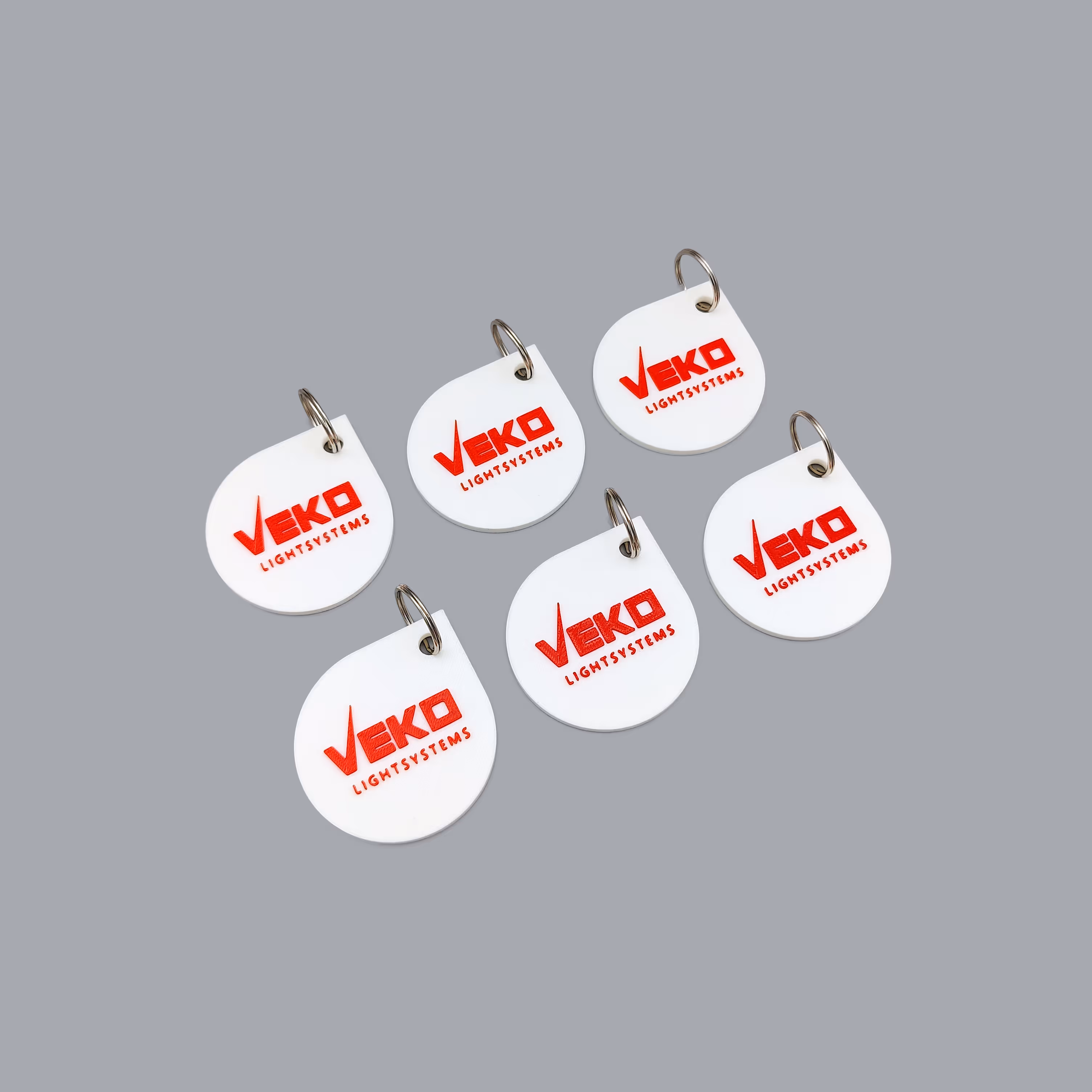 Serie sleutelhangers voor Veko geproduceerd in PLA-filament via 3D-print door Antistatic in Antwerpen.