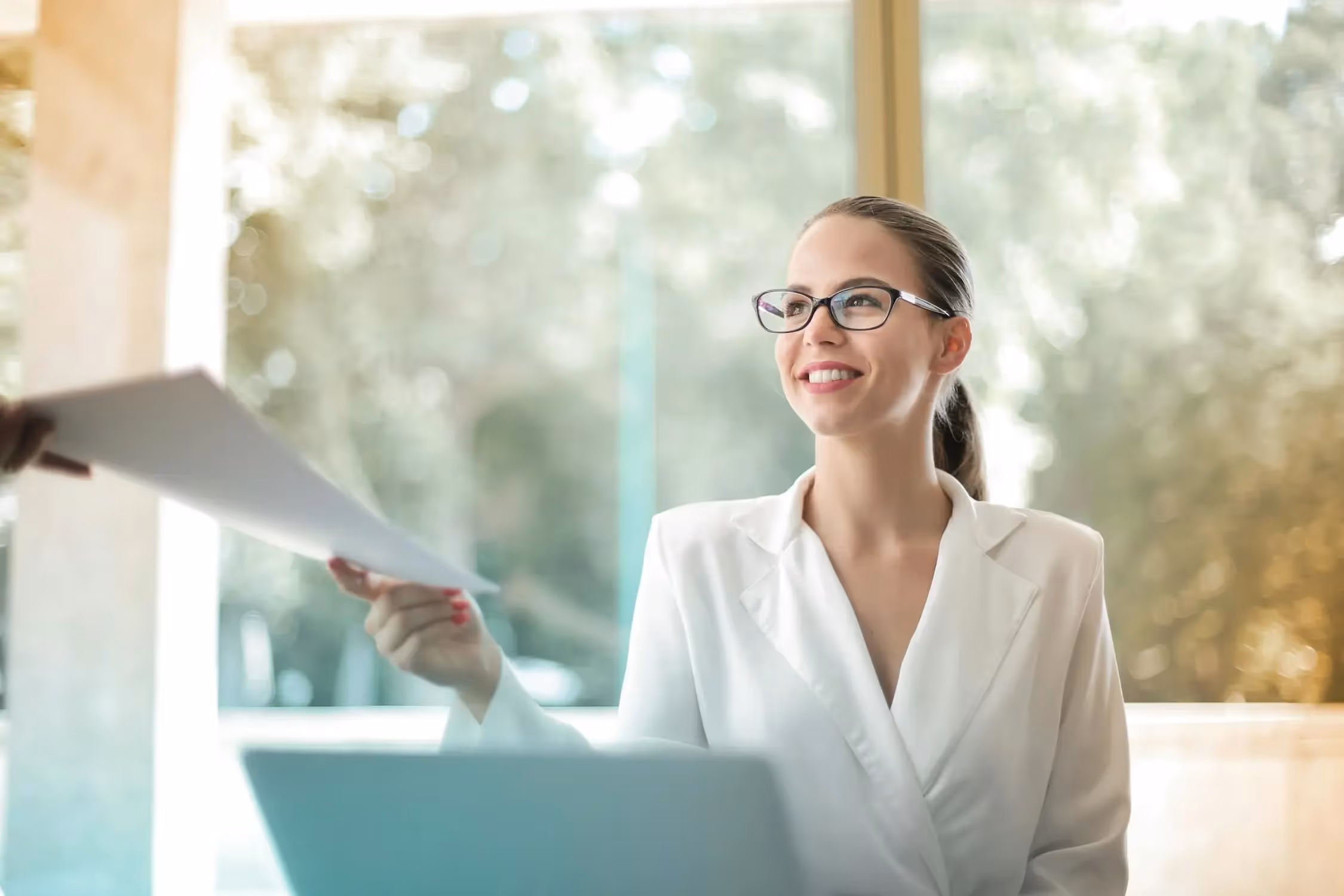 A photo of a project manager handing over a project report.