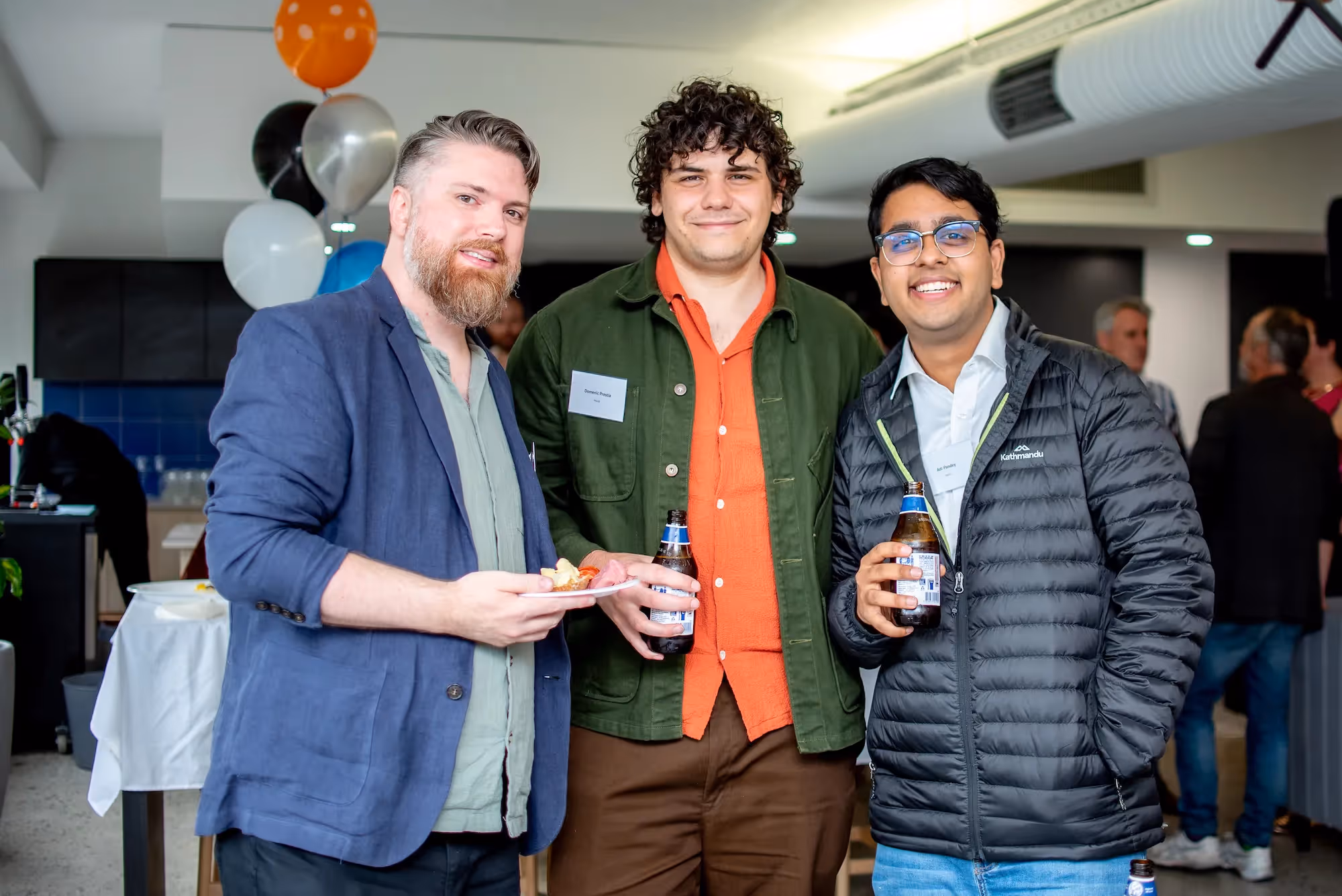 Meet our Software Engineer Intern Adi Pandey: Three computer science professionals holding drinks and food at a Project management networking event