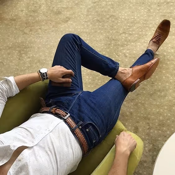 Buiness Casual Dress Code for Client-Side Project Managers: An image of a person sitting on the chair emphasing the belt and the watch.
